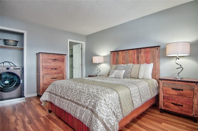 bedroom with wood finished floors, a textured ceiling, and baseboards