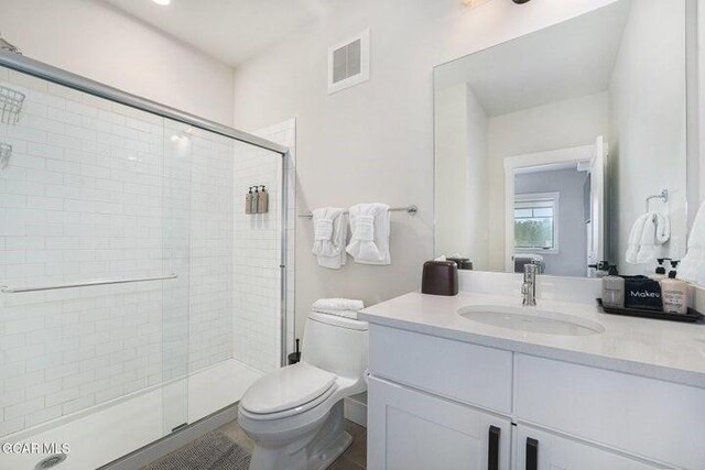 78311 US Highway 40 Unit 6, Winter Park, CO 80482 - bathroom featuring vanity, visible vents, a shower stall, and toilet