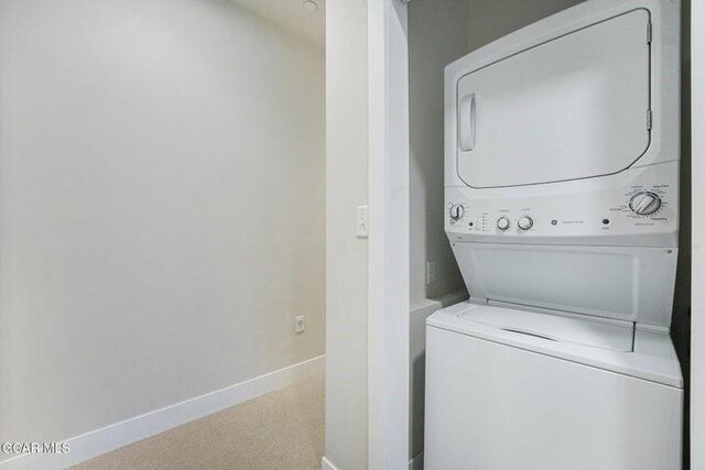 78311 US Highway 40 Unit 6, Winter Park, CO 80482 - washroom featuring baseboards, stacked washer and dryer, and laundry area