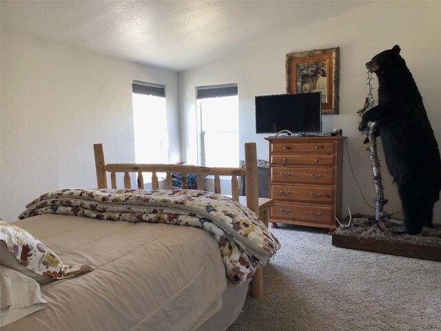 bedroom featuring lofted ceiling and carpet floors