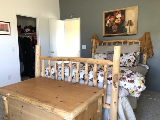 carpeted bedroom featuring a spacious closet and a closet