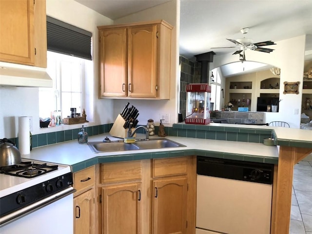 kitchen featuring range with gas cooktop, white dishwasher, a sink, a peninsula, and under cabinet range hood