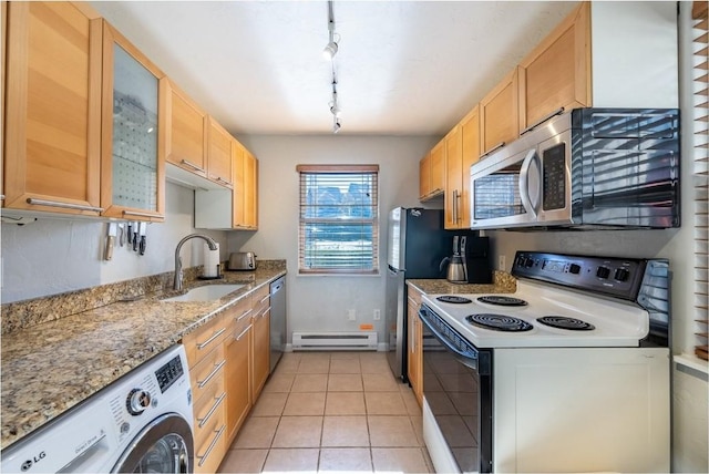 kitchen featuring stainless steel appliances, track lighting, a sink, washer / dryer, and a baseboard heating unit