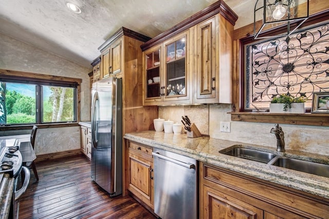 432 Bighorn Cir, Silverthorne, CO 80498 - kitchen with appliances with stainless steel finishes, lofted ceiling, brown cabinets, dark wood-style floors, and light stone counters