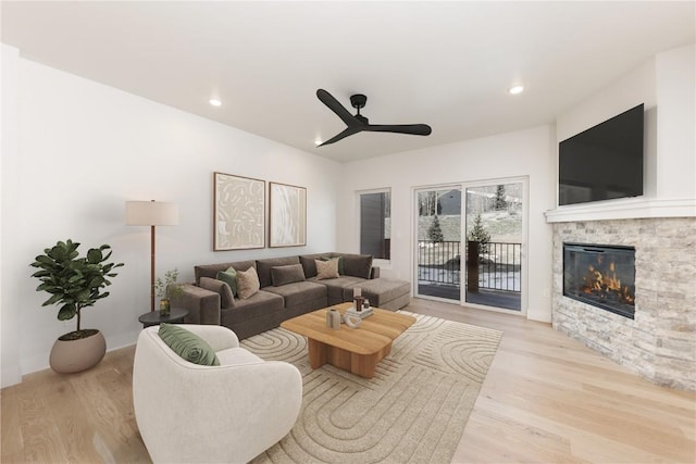 35 Argentine Ct Unit 303, Keystone, CO 80435 - living area with a ceiling fan, wood finished floors, a stone fireplace, and recessed lighting
