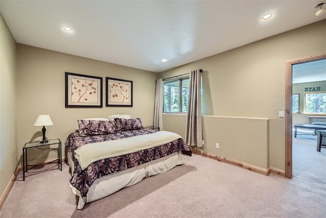 carpeted bedroom with multiple windows and recessed lighting
