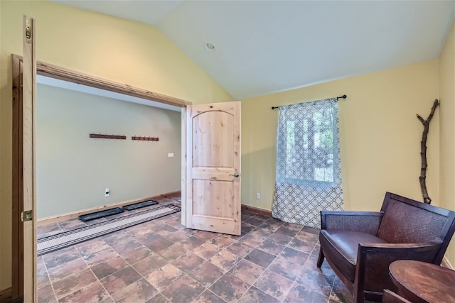 sitting room with lofted ceiling and baseboards