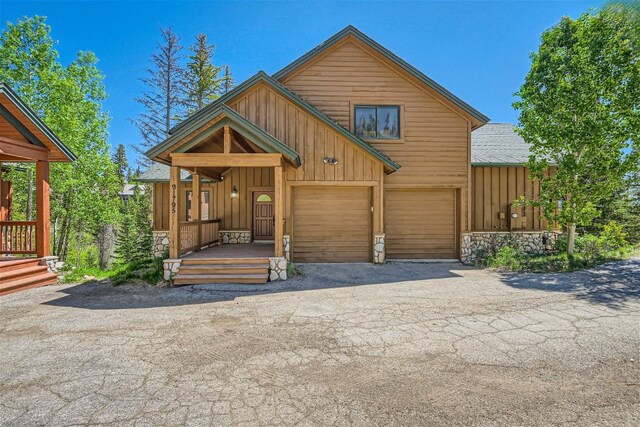 91795 Ryan Gulch Rd, Silverthorne, CO 80498 - rustic home featuring aphalt driveway, stone siding, board and batten siding, and a garage