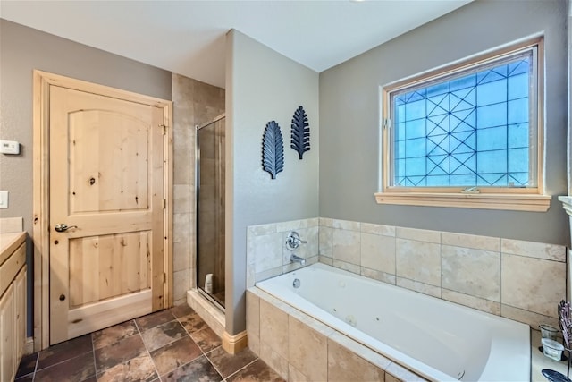 bathroom with vanity, a whirlpool tub, and a stall shower