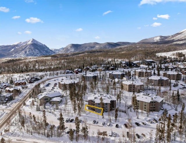 snowy aerial view featuring a mountain view