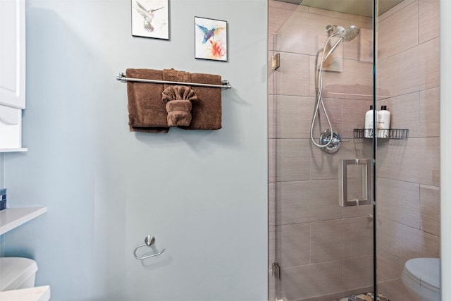 full bath featuring toilet and a stall shower
