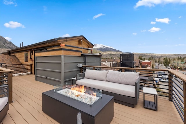 317 Granite St Unit 5, Frisco, CO 80443 - wooden deck featuring a mountain view and an outdoor living space with a fire pit