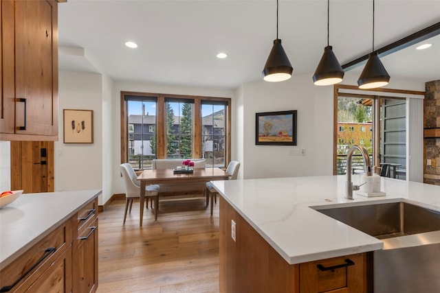 317 Granite St Unit 5, Frisco, CO 80443 - kitchen featuring a sink, brown cabinetry, light wood-type flooring, pendant lighting, and recessed lighting