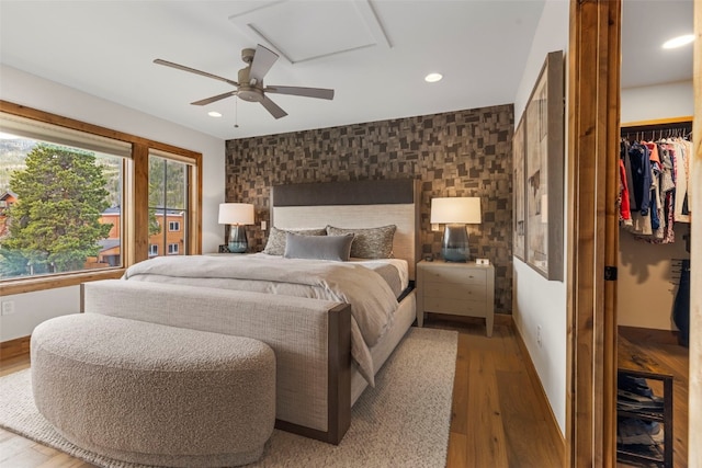 317 Granite St Unit 5, Frisco, CO 80443 - bedroom with wood finished floors, recessed lighting, an accent wall, a spacious closet, and baseboards
