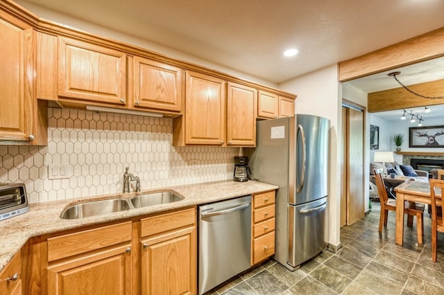 23004 US Highway 6 Unit 103, Keystone, CO 80435 - kitchen featuring stainless steel appliances, tasteful backsplash, recessed lighting, light stone counters, and a glass covered fireplace