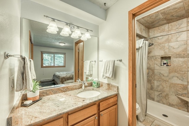 23004 US Highway 6 Unit 103, Keystone, CO 80435 - ensuite bathroom featuring vanity, tiled shower, and a textured ceiling
