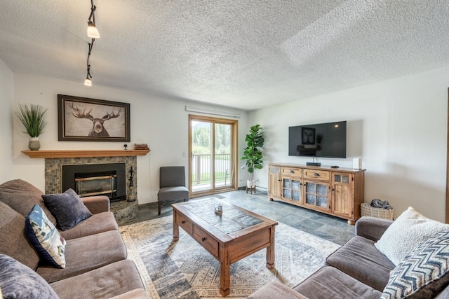 23004 US Highway 6 Unit 103, Keystone, CO 80435 - living area featuring a tile fireplace, track lighting, and a textured ceiling