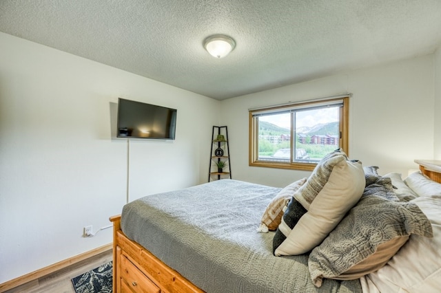 23004 US Highway 6 Unit 103, Keystone, CO 80435 - bedroom featuring wood finished floors and a textured ceiling
