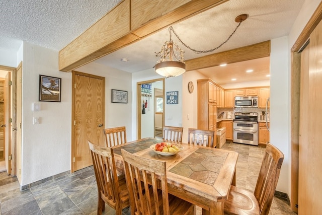 23004 US Highway 6 Unit 103, Keystone, CO 80435 - dining area with a textured ceiling, beam ceiling, and light stone finish floors