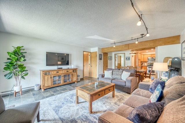 23004 US Highway 6 Unit 103, Keystone, CO 80435 - living area with track lighting, a textured ceiling, and a baseboard radiator