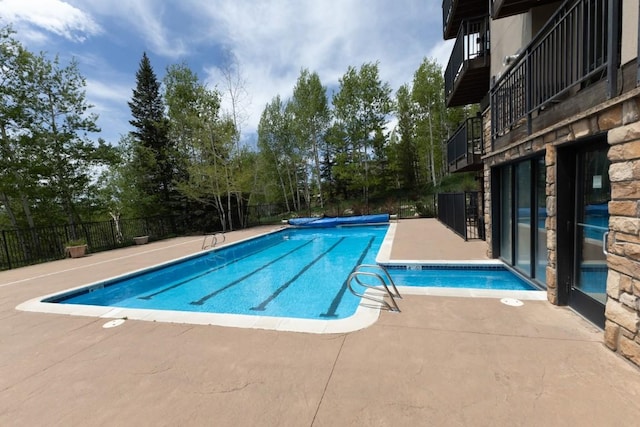 2883 Burgess Creek Rd Unit 203, Steamboat Springs, CO 80487 - community pool featuring fence, a patio, and view of scattered trees