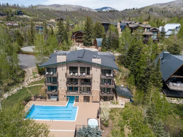 2883 Burgess Creek Rd Unit 203, Steamboat Springs, CO 80487 - aerial view of property and surrounding area featuring a mountain backdrop and a pool