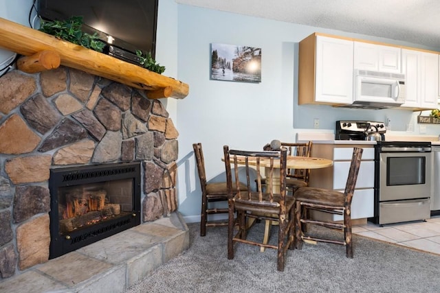 2883 Burgess Creek Rd Unit 203, Steamboat Springs, CO 80487 - dining room featuring a stone fireplace and light tile patterned floors