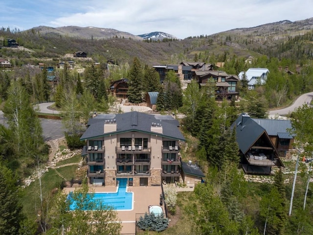 2883 Burgess Creek Rd Unit 203, Steamboat Springs, CO 80487 - aerial view of property and surrounding area with a pool and mountains