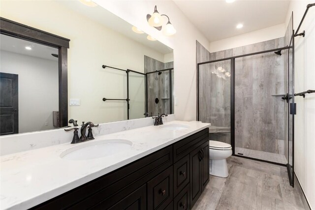 750 Independence Rd Unit 2C, Keystone, CO 80435 - full bathroom featuring a shower stall, toilet, double vanity, wood finished floors, and recessed lighting