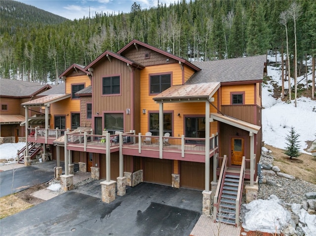 750 Independence Rd Unit 2C, Keystone, CO 80435 - view of front of property with a wooded view, stairs, and asphalt driveway