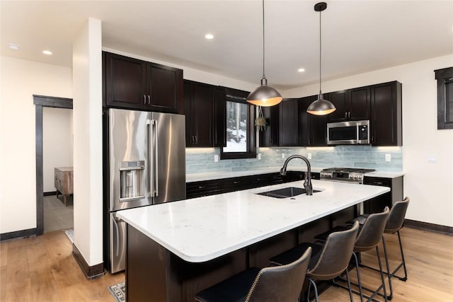 750 Independence Rd Unit 2C, Keystone, CO 80435 - kitchen with stainless steel appliances, a sink, baseboards, backsplash, and light wood-style floors