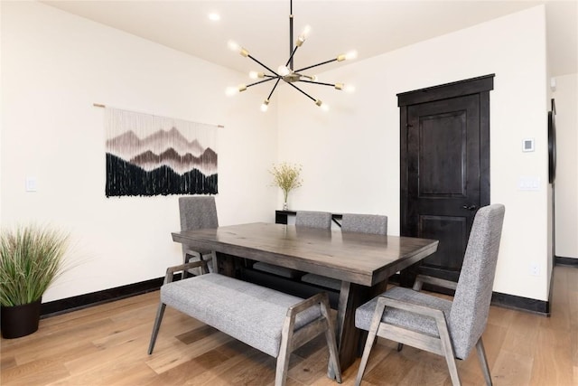750 Independence Rd Unit 2C, Keystone, CO 80435 - dining space featuring a chandelier, light wood-type flooring, and baseboards