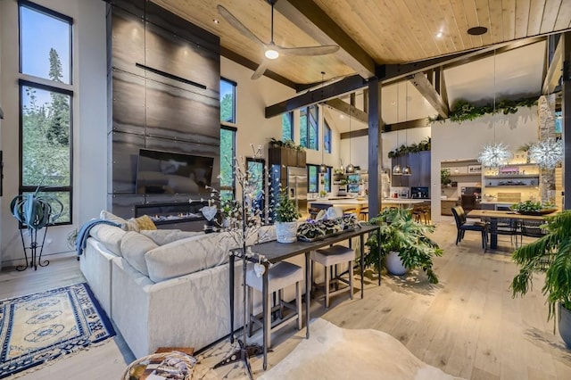313 Raven Golf Ln, Silverthorne, CO 80498 - living room with wood-type flooring, high vaulted ceiling, a wooden ceiling with exposed beams, and a ceiling fan