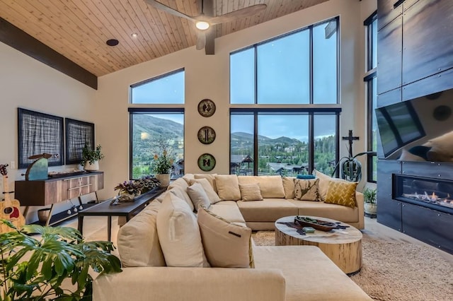 313 Raven Golf Ln, Silverthorne, CO 80498 - living room with wooden ceiling, a high ceiling, and a glass covered fireplace