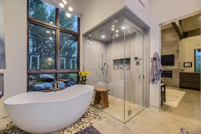 313 Raven Golf Ln, Silverthorne, CO 80498 - bathroom featuring a shower stall, a freestanding bath, vanity, and a high ceiling
