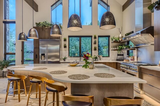 313 Raven Golf Ln, Silverthorne, CO 80498 - kitchen featuring high quality appliances, island range hood, a high ceiling, light countertops, and open shelves
