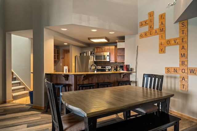 2800 Village Dr Unit 1302, Steamboat Springs, CO 80487 - dining area featuring wood finished floors, recessed lighting, baseboards, and stairway