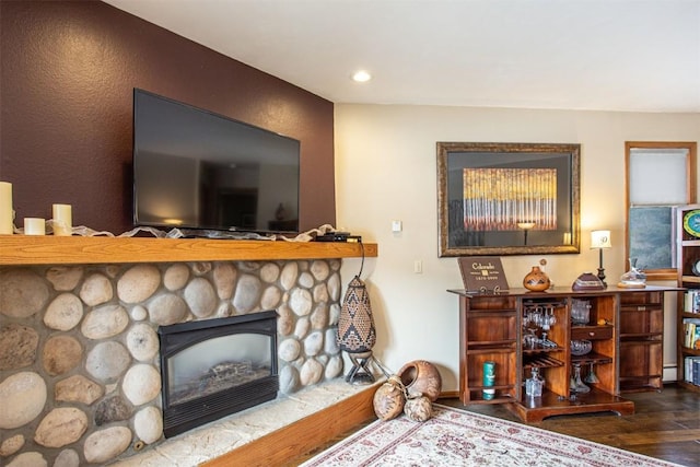 living area featuring a fireplace, wood finished floors, and recessed lighting