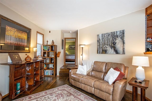 living area featuring baseboards and wood finished floors