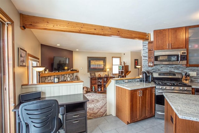 kitchen with brown cabinetry, beam ceiling, light stone countertops, tasteful backsplash, and appliances with stainless steel finishes