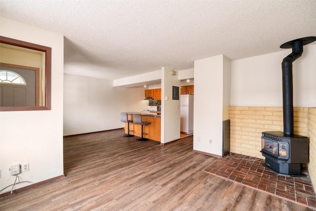 13 Sequoia Ct Unit 13, Steamboat Springs, CO 80487 - unfurnished living room with baseboards, a wood stove, and a textured ceiling