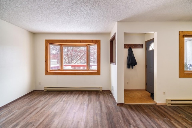 13 Sequoia Ct Unit 13, Steamboat Springs, CO 80487 - unfurnished room with baseboard heating, wood finished floors, a textured ceiling, and a baseboard radiator