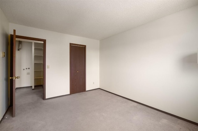 13 Sequoia Ct Unit 13, Steamboat Springs, CO 80487 - unfurnished bedroom featuring baseboards, carpet flooring, a textured ceiling, and a closet
