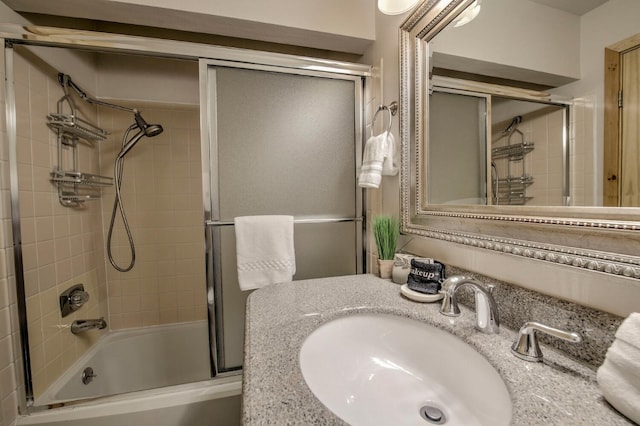 full bathroom with vanity and combined bath / shower with glass door