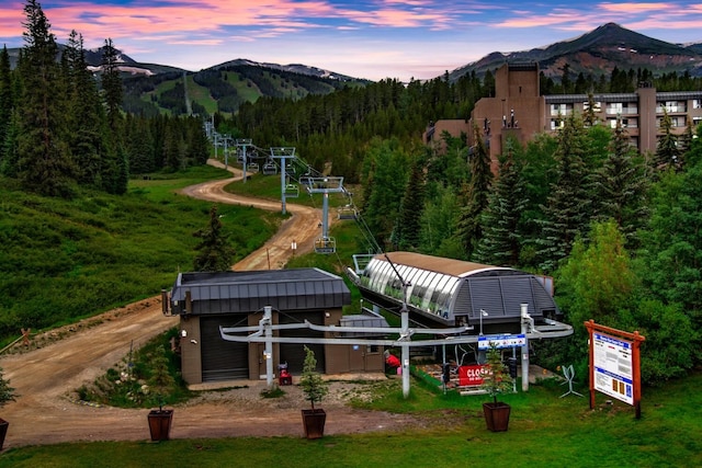 view of home's community with a mountain view and a view of trees