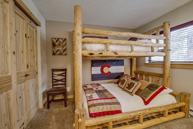 carpeted bedroom featuring a textured ceiling and baseboards
