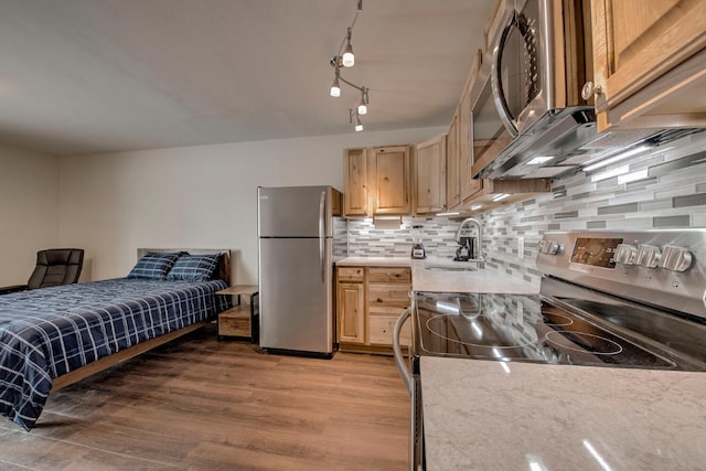 1133 Straight Creek Dr Unit 108, Dillon, CO 80435 - kitchen with appliances with stainless steel finishes, decorative backsplash, light wood-style flooring, and light brown cabinetry
