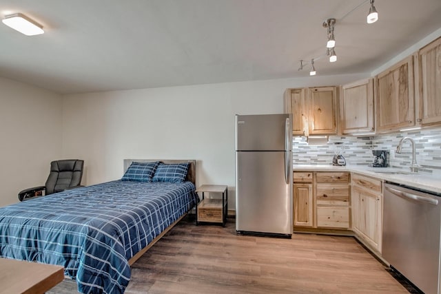 1133 Straight Creek Dr Unit 108, Dillon, CO 80435 - bedroom with freestanding refrigerator, light wood finished floors, and track lighting
