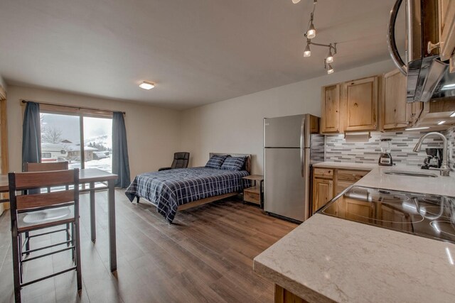 1133 Straight Creek Dr Unit 108, Dillon, CO 80435 - bedroom with freestanding refrigerator and wood finished floors