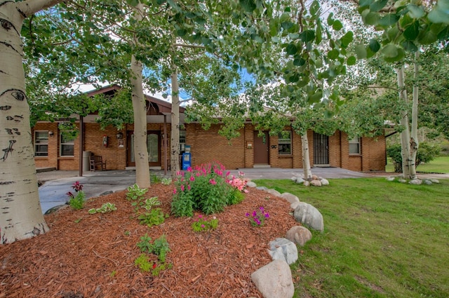 1133 Straight Creek Dr Unit 108, Dillon, CO 80435 - view of front of house with brick siding and a front lawn